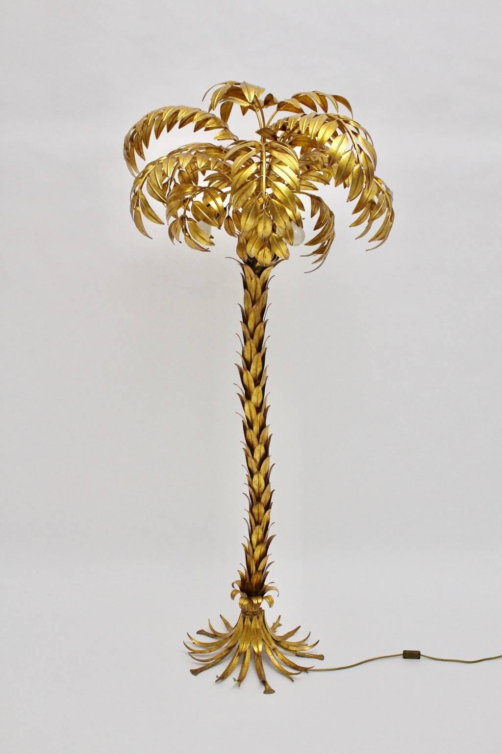 The huge gold-plated floor lamp shaped like a palm tree was designed by Hans Kögl.

Three bulbs E 27 are hidden at the tree crown and create a wonderful warm light blaze.

A must have for a great home interior.