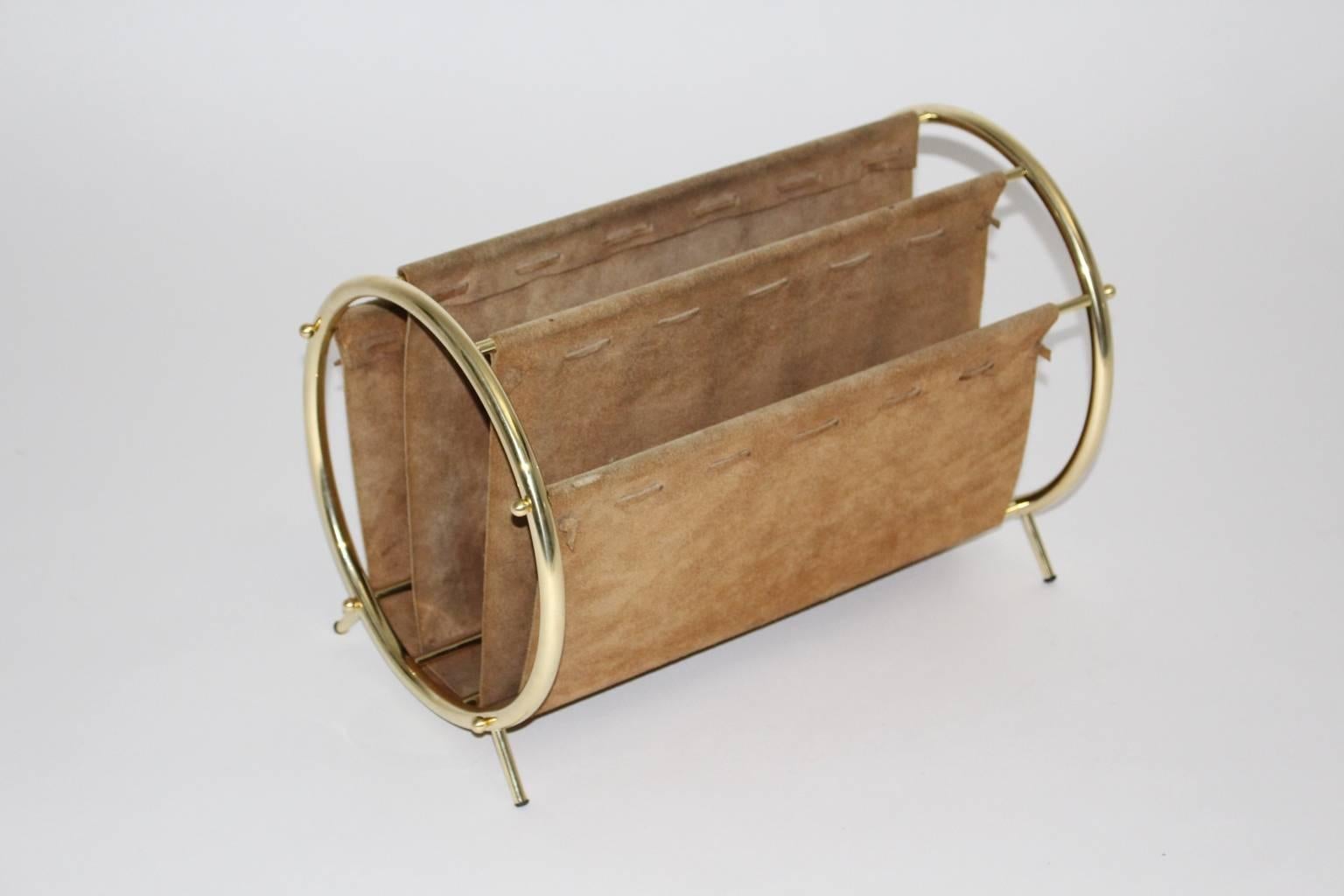 The mid century modern vintage magazine rack was made of brass tube frame and brown suede leather.
The interior of the magazine rack has four compartments for your newspaper.
All measures are approximate.
 