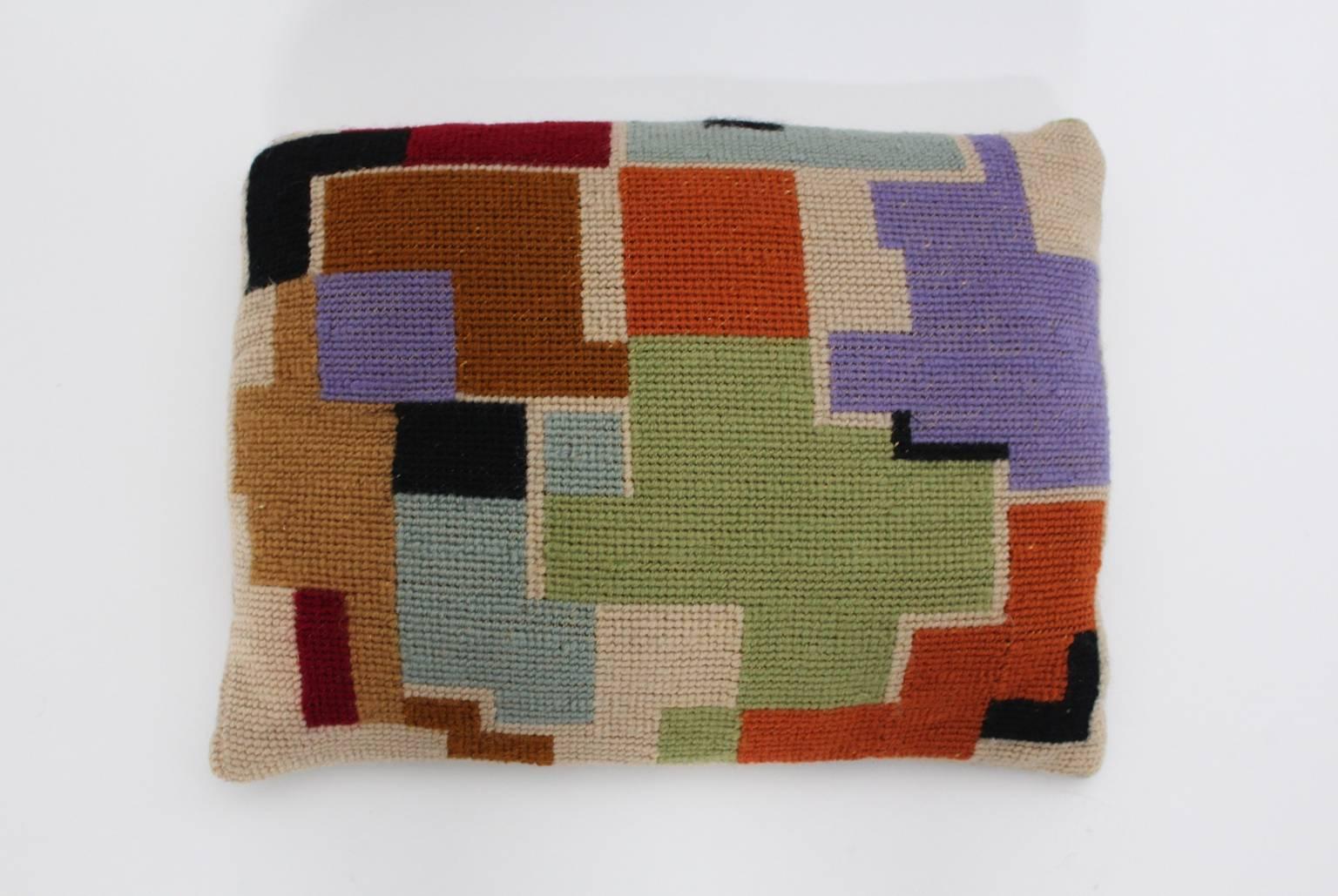 The vintage pillow features a multicolored embroidery with Bauhaus geometric design and comes with an insert.
Both sides show different geometric pattern colored in black, green, lilac, light blue, brown, ivory, orange and red.

The original vintage