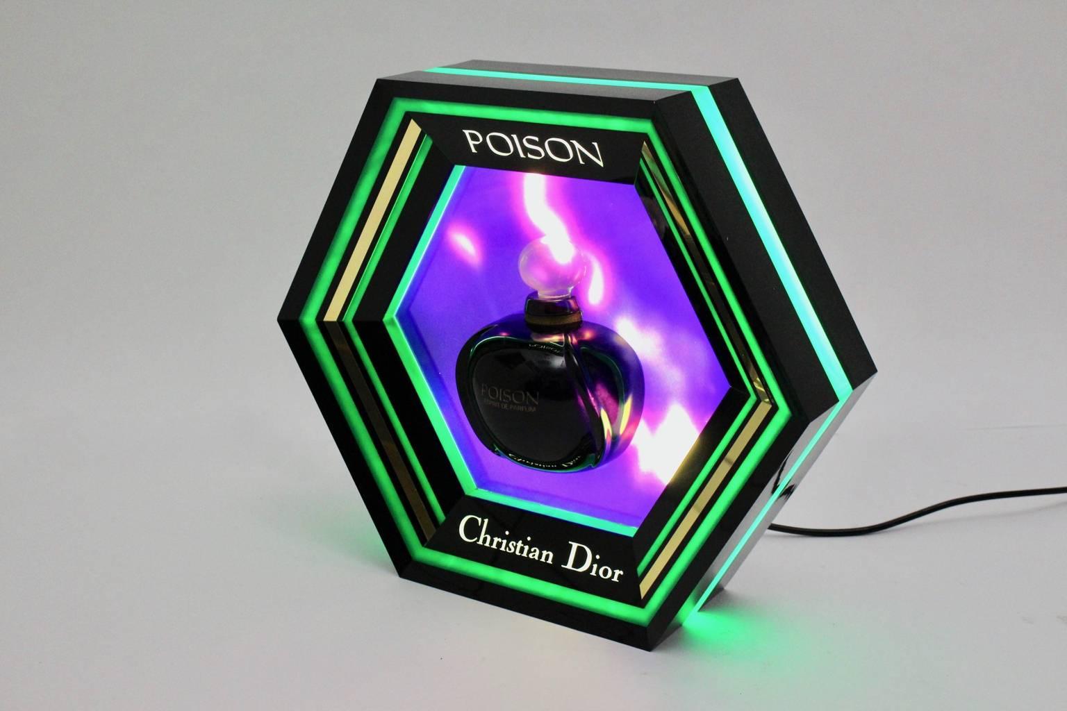 Extraordinary octagonal billboard light in the colors green, black and violet for the Parfum Poison by Christian Dior.

The parfumeur Edouard Flechier has created the Parfum Poison for Christian Dior in 1985.

The billboard light is made of plastic.