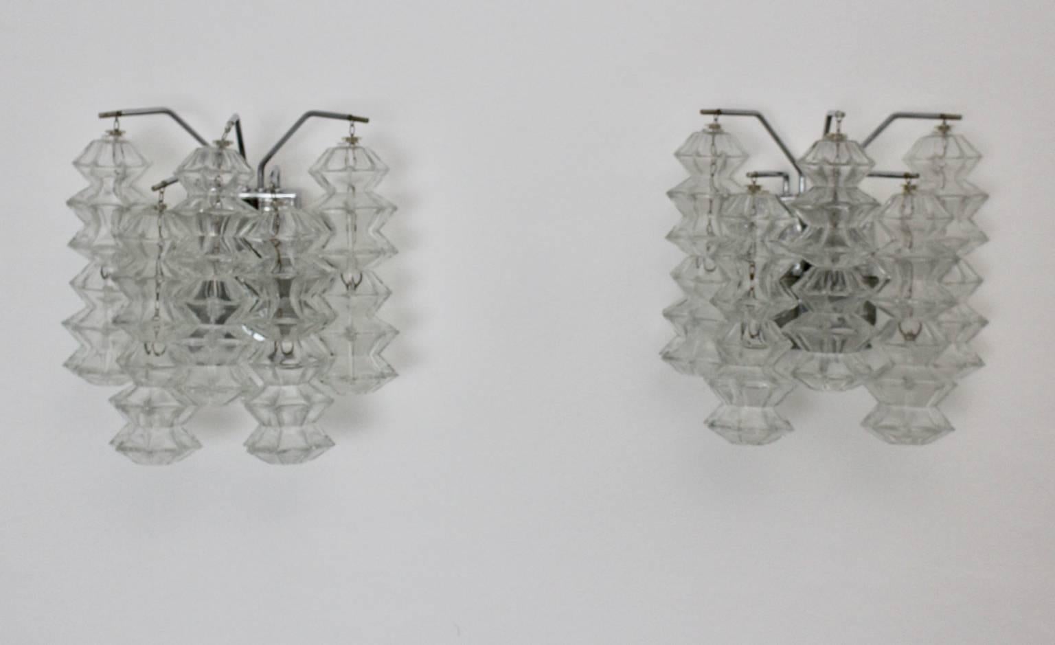 Mid Century Modern vintage glass chromed metal pair of  Pagoda sconces  by Kalmar, circa 1969, Vienna 
Each sconce shows ten pagoda shaped glasses and three sockets Edison E 14.

The condition of the sconces is very good with very minor signs of age