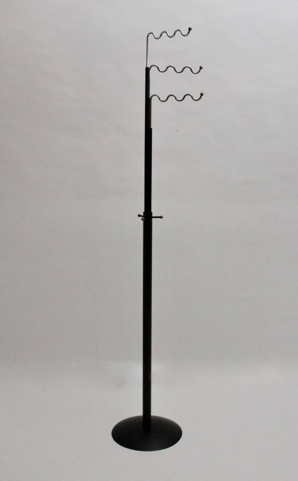 The coat rack by Markus Boergens has a stem, which is made of metal black lacquered, and three chromed swiveling coat hooks shaped like waves.

In the middle of the stem are three hooks for hanging coats or umbrellas.