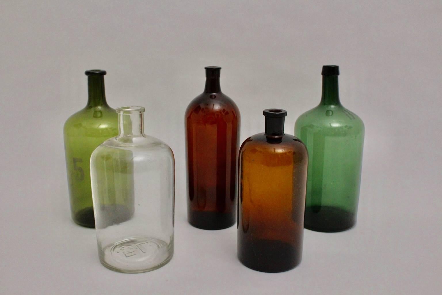 Five handblown wine bottles in the colors brown, green and colorless with various measures from 3 liters to 5 liters.

The condition is excellent. The set of five bottles are carefully cleaned and all five bottles have no spots or chips.

The