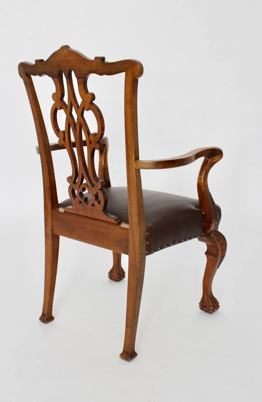 Art deco era vintage chippendale style armchair or side chair or desk chair from solid walnut.
Richly carved with a beautiful backrest and ball and claws feet.
The armchair was produced circa 1920.
While the seat of the armchair is covered with real