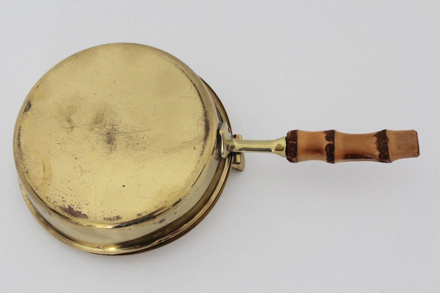 Mid century modern vintage cover pan, which was designed and executed in Vienna, circa 1960.
While the stem was made of bamboo, the lidded pan was made of solid brass.
The original condition is very good with very nice brass patina.
 All measures