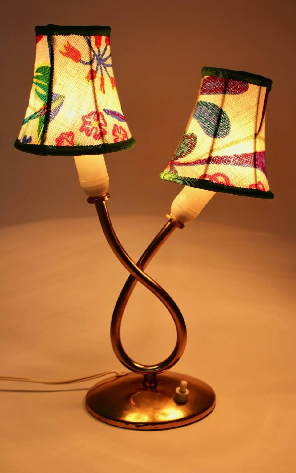 This pretty curved and charming brass vintage table lamp was made of brass and was designed by Josef Frank for Svenskt Tenn, Sweden, 1950.

Also the lamp shades are renewed and covered with high-quality Josef Frank hand printed colorful textile