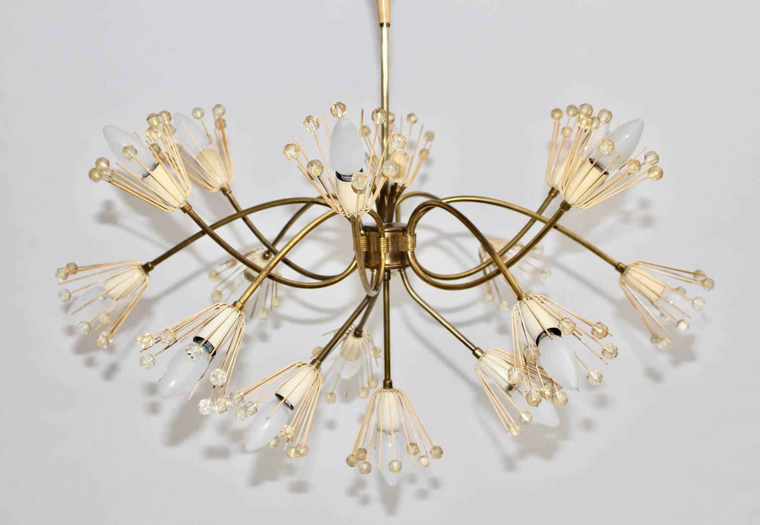 The mid century modern brass vintage chandelier or pendant, which is shaped like a snowflake, was designed by Emil Stejnar 1955 Vienna and manufactured by Rupert Nikoll Vienna, Austria.
The sixteen lights chandelier shows curved brass arms with cut