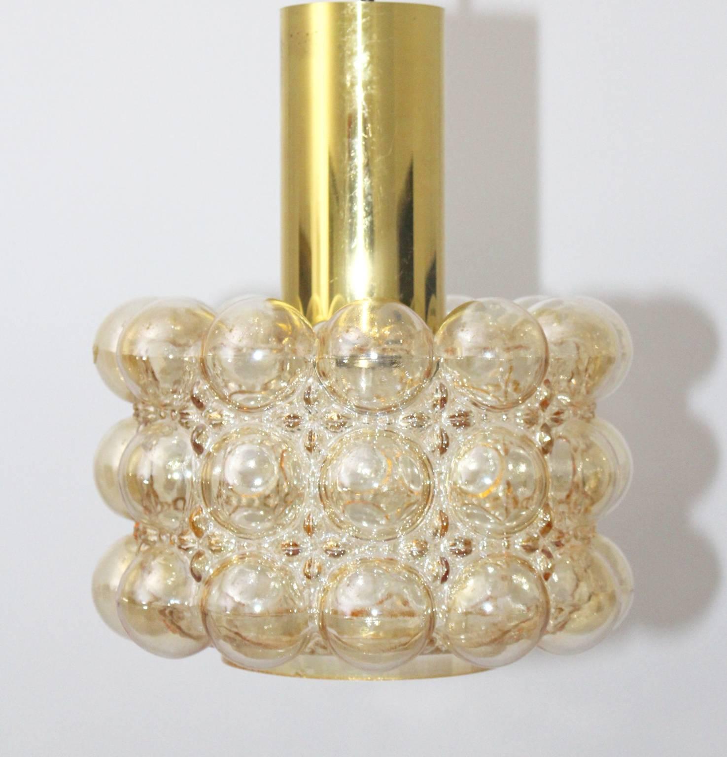 Mid century modern vintage pendant or chandelier designed by Helena Tynell and manufactured by Glashütte Limburg, Germany, 1960s.
The amber colored glass shade has nice bubbles and the stem was made of brass.
One E 27 socket.
all measures are