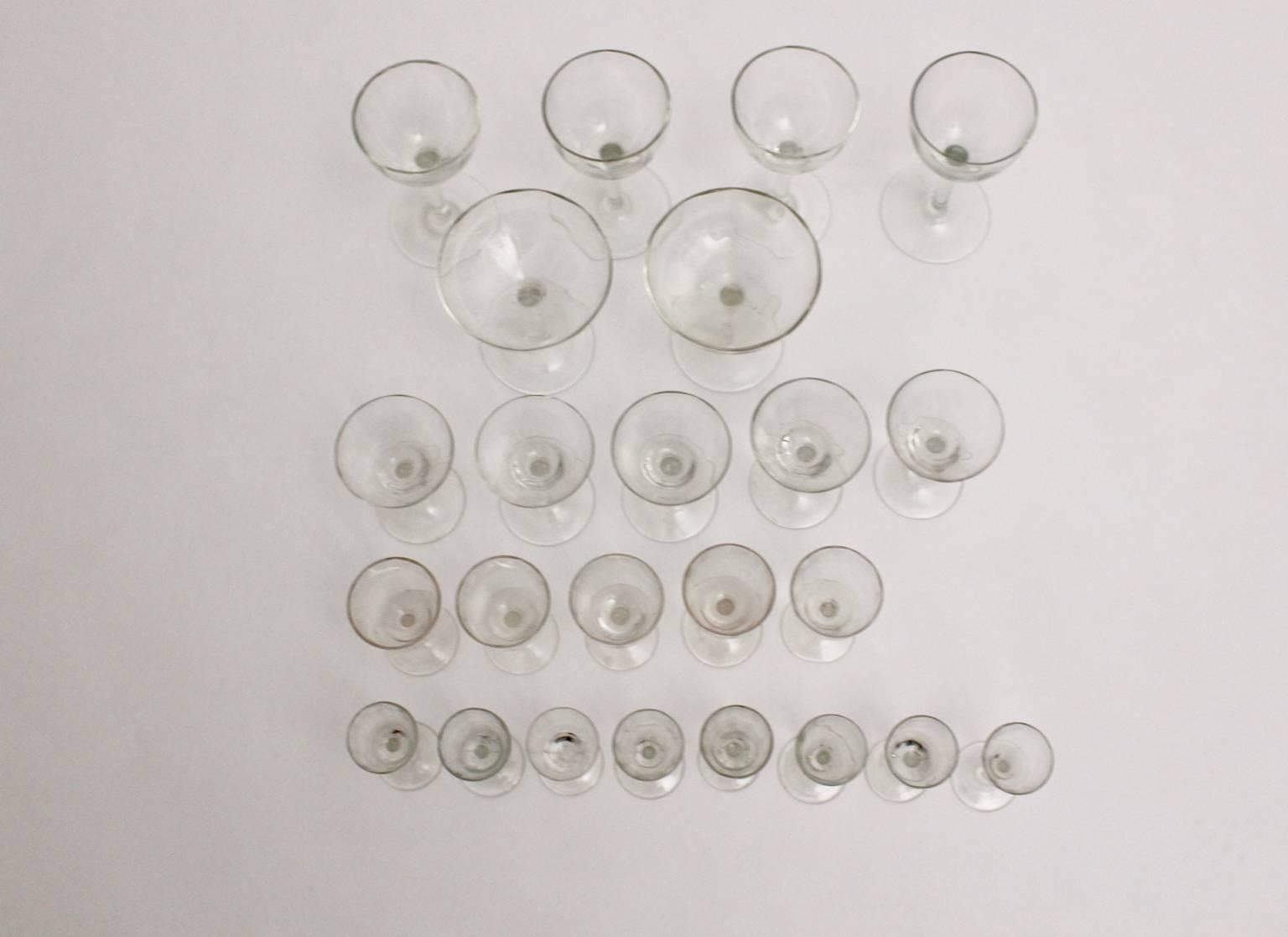 Jugendstil glassware or barware designed and manufactured in Vienna circa 1910.
A best quality sophisticated convolute of clear glassware consists of 24 pieces colorless handblown stem glasses in very good condition without chips or spots.
This