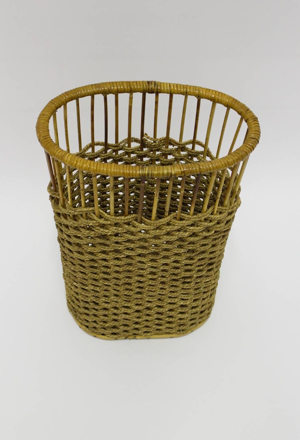 Mid century modern vintage rattan paper basket designed and executed in Austria, circa 1960.
The oval shaped paper basket was made out of rattan and sisal cords and features a chipboard bottom.
all measures are approximate