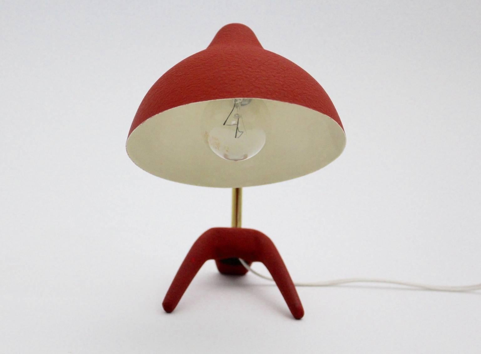 A beautiful mid century modern red table lamp, which was designed by Louis Kalff, 1950s, and executed by Philips, Netherlands.
The lamp shows a cast iron foot and a curved brass stem.
Furthermore the table lamp has a conical aluminium shade, which