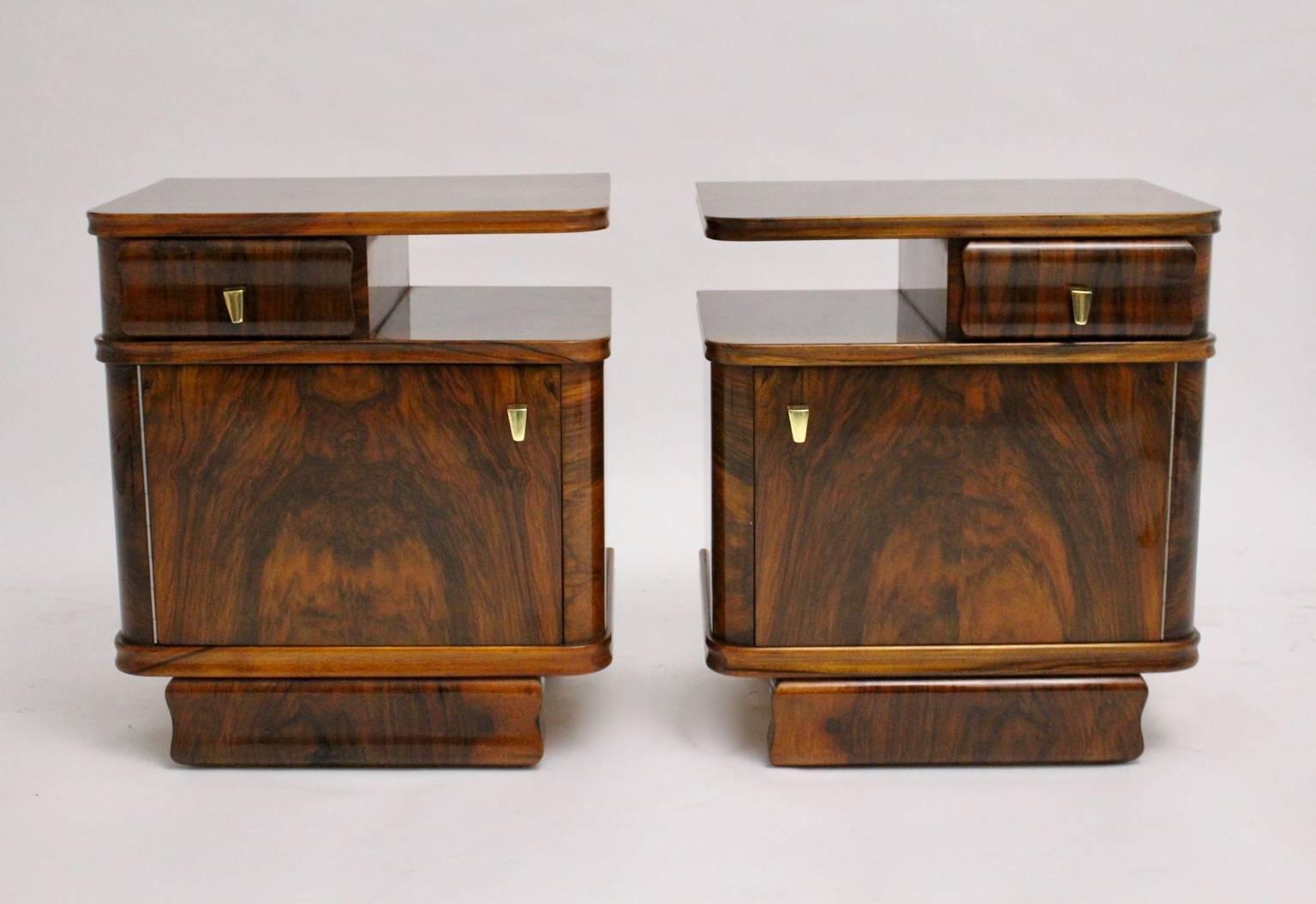 A beautiful pair of Art Deco brown walnut nightstands, which were designed and executed in Austria, 1930s.
The drawer and the door are equipped with original solid brass handles, while the surface of the chests has an impressive grain. The color is