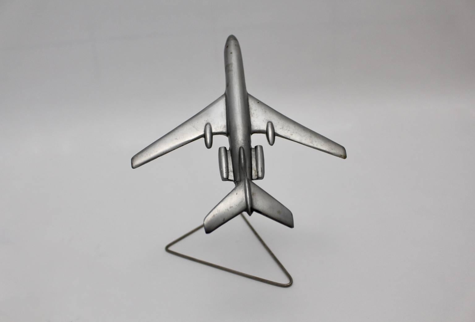 This airplane model was made of aluminium and was designed and executed in the 1960s.
It features a metal holder.

The condition is very good with beautiful patina.