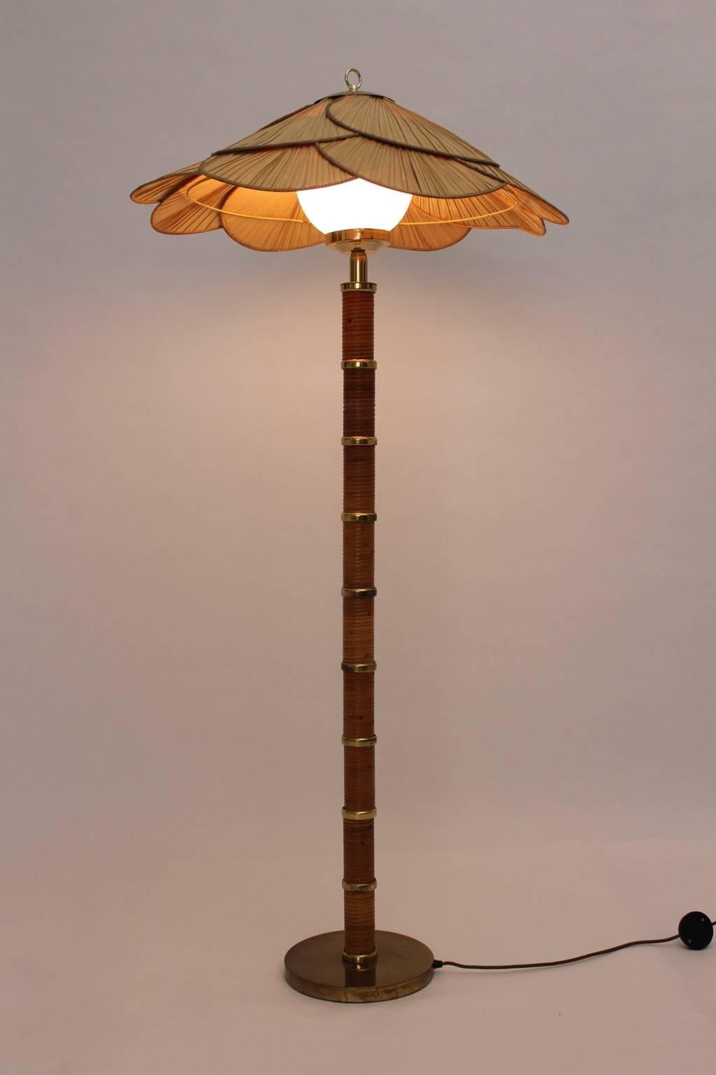 This very rare floor lamp was designed by Ingo Maurer, 1970s, Germany.
The materials are: rattan, brass, opal glass ball and exotic leaves.

The base is in very good condition with nice patina.
The lamp shade was made of exotic leaves and shows