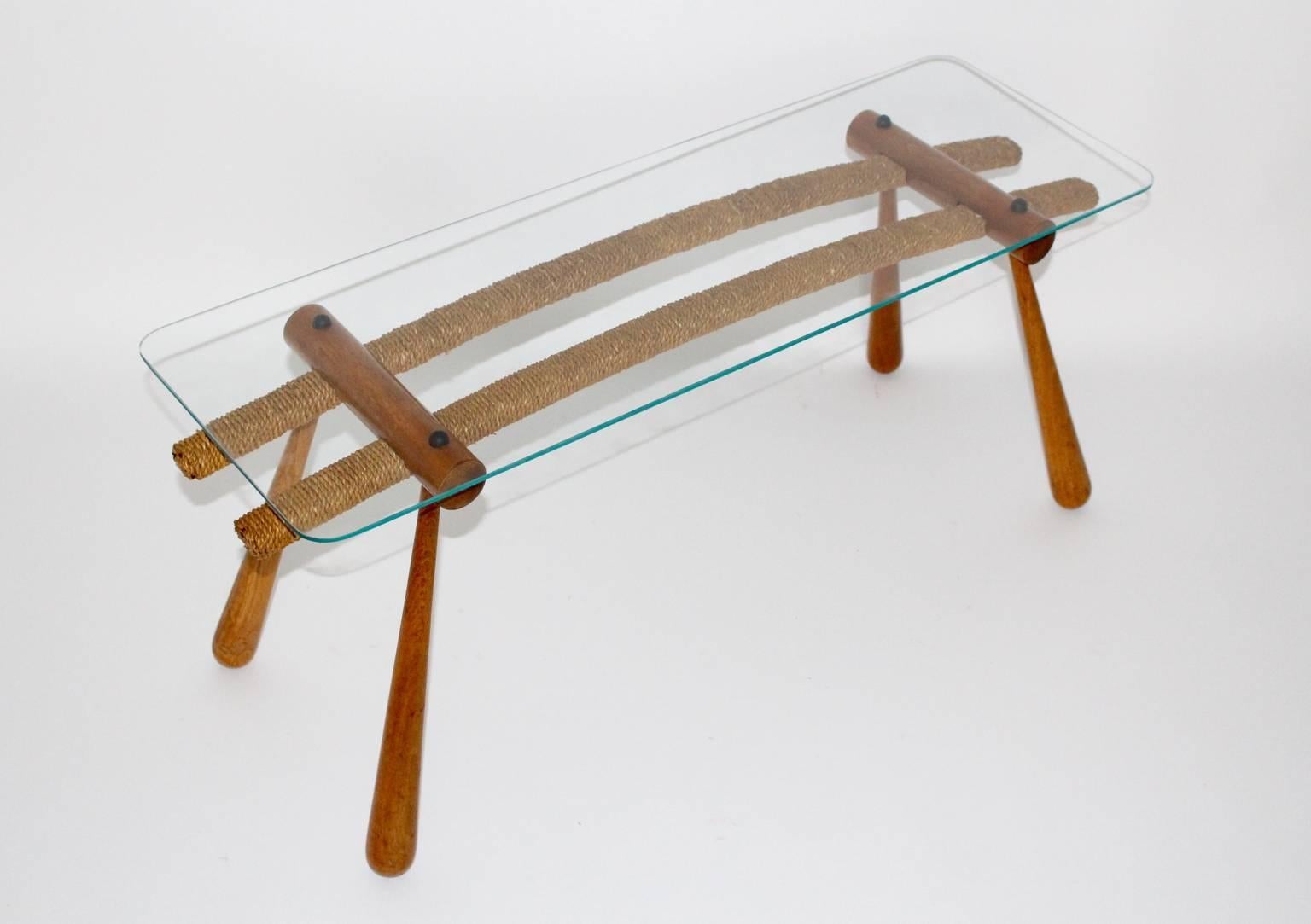Mid Century Modern vintage coffee table or sofa table from maple and glass designed by Max Kment and executed by Kunstgewerbliche Werkstätten Max Kment, circa 1950.
This coffee table consists of maple tree, cord and a clear glass plate.
The coffee