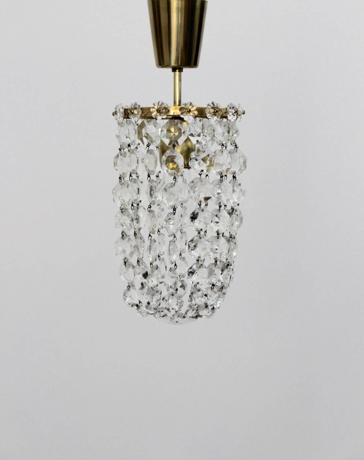 This lovely cut crystal glass chandelier was designed and manufactured
by Bakalowits & Soehne, Vienna 1950s.
The material of the frame is brass also the lampshade was decorated with 112 cut crystal glass and 14 glass flowers.
The chandelier features