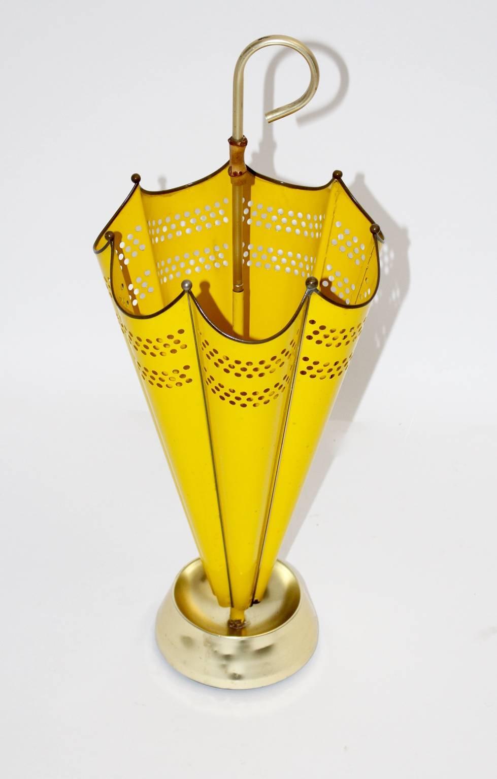 A mid century modern vintage yellow umbrella stand, which is shaped like an umbrella.
Furthermore it was designed and manufactured during the 1950s, Italy.
The umbrella stand was partly made of perforated sheetmetal and lacquered in a sunny yellow