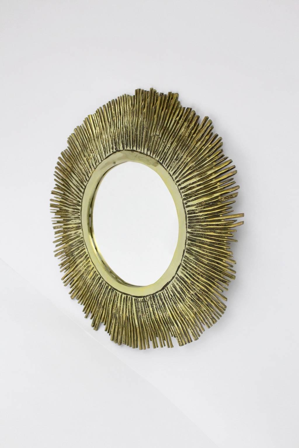 We present a huge solid brass cast sunburst mirror, which was designed in France during the 1960s.
The original condition is very good.

Measure: 
Total diameter is 63 cm 
The glass diameter is 29 cm 
The depth is 2 cm.
 