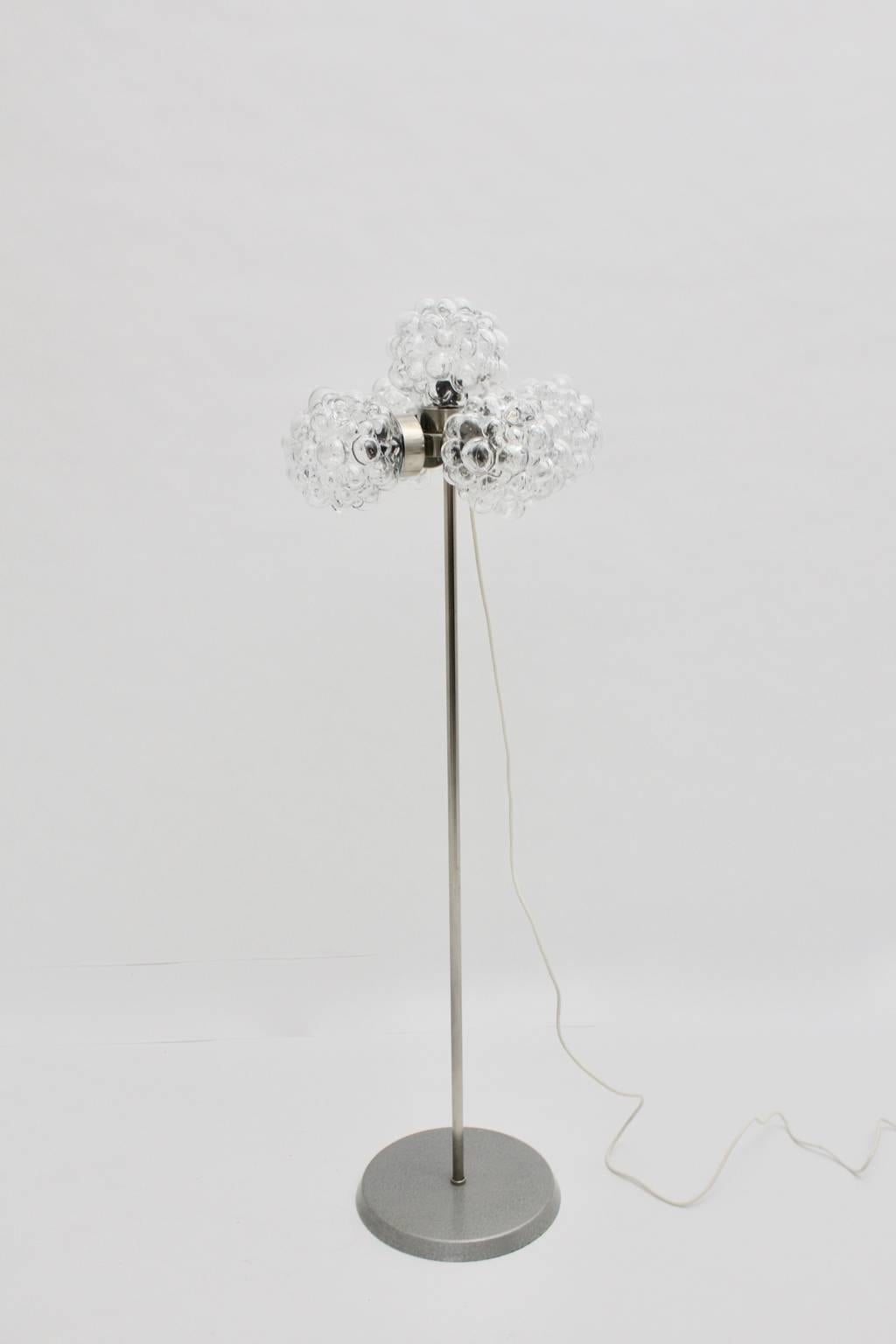 This presented stainless steel floor lamp was designed very similar to Helena Tynell, Germany, 1970s.
The lamp consists of five clear glass bubbles shades and lights with five bulbs socket E 27.
The metal base is grey lacquered. On/off switch
The