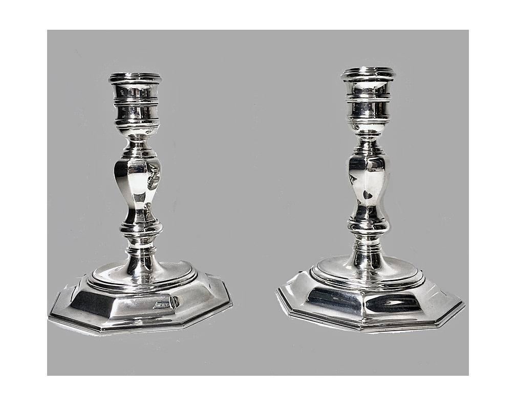 Pair of English silver Georgian style candelabra candlesticks, London, 1968, Garrard & Co. Each in the Georgian style with octagonal bases and knopped baluster stems, supporting two-light branches. Measures: Height 7.75 inches, breadth 8 inches,