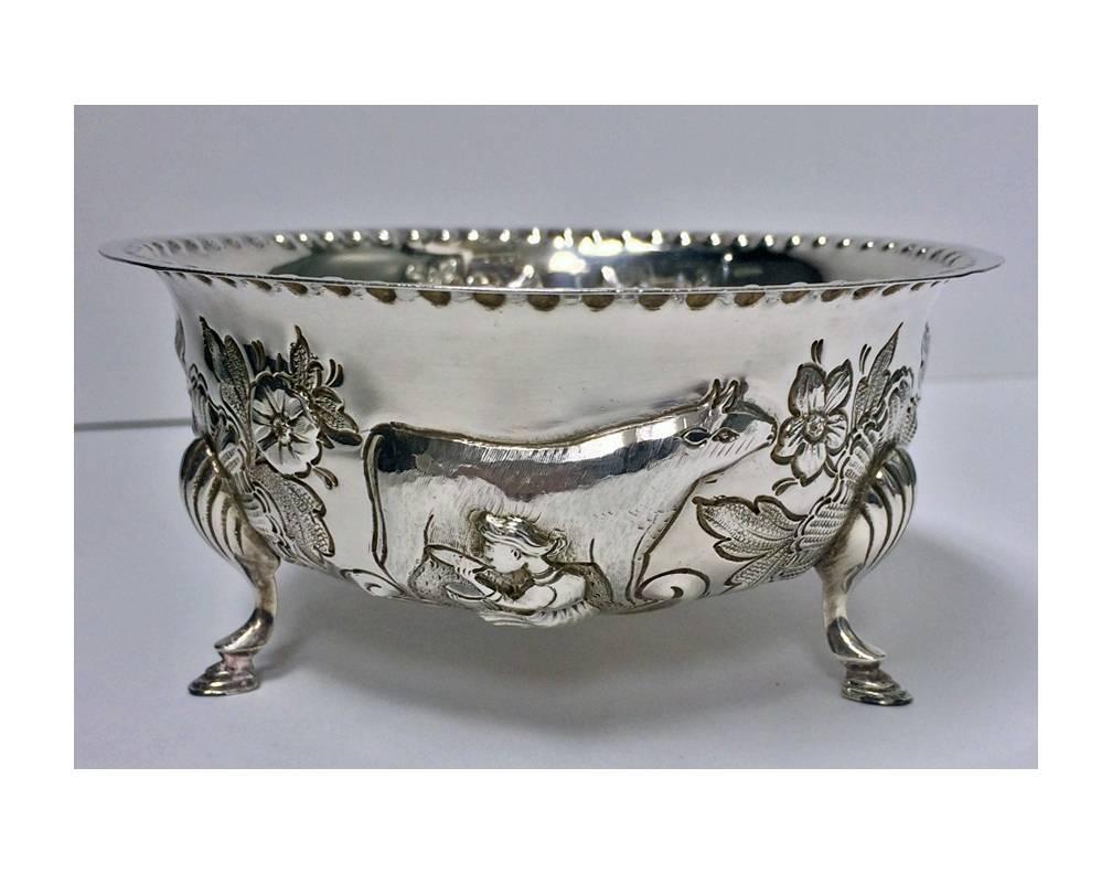 Irish style silver cream jug and a matching sugar bowl, Birmingham, 1913-1914, Williams Ltd. Each richly repousse and decorated in the Irish style with animals, flowers and scrolls, on three shell knuckle feet, punch bead borders. Sugar: 4.75 x