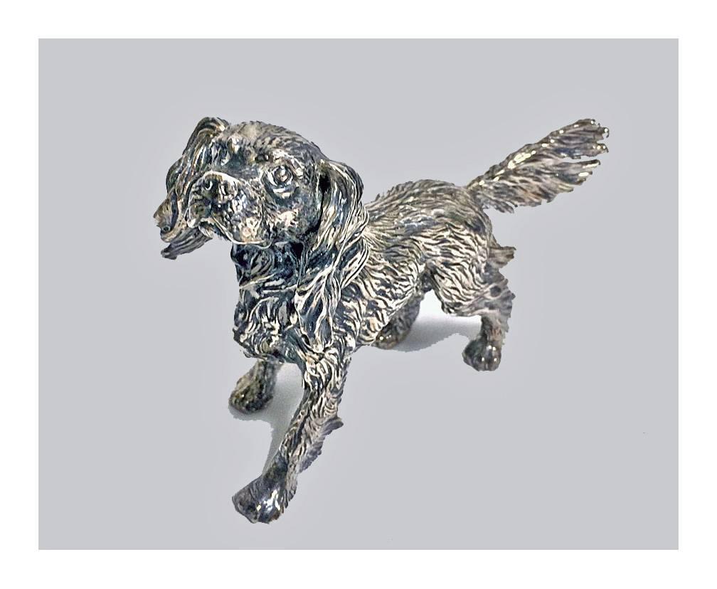Sterling silver spaniel dog figurine. The dog realistically modelled and textured. Stamped 925. Measures: Approximately 5.75 x 4 inches. Item weight: 135.63 grams.