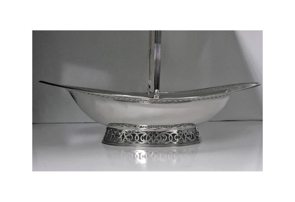 Georgian silver cake basket, London 1796, poss Thomas Chawner. The oval shaped basket with pedestal reed base, border pierced surround, upper section with outer reed design border and pierced guilloche intertwining ribbon. The center plain, crest