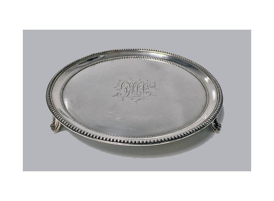 Antique George 111 silver salver, London, 1785 by Elizabeth Jones. The salver on three turned bead supports the outer and inner borders of bead design, the otherwise plain centre engraved with monogram TIKG in fancy script. Diameter: approx. 6.5