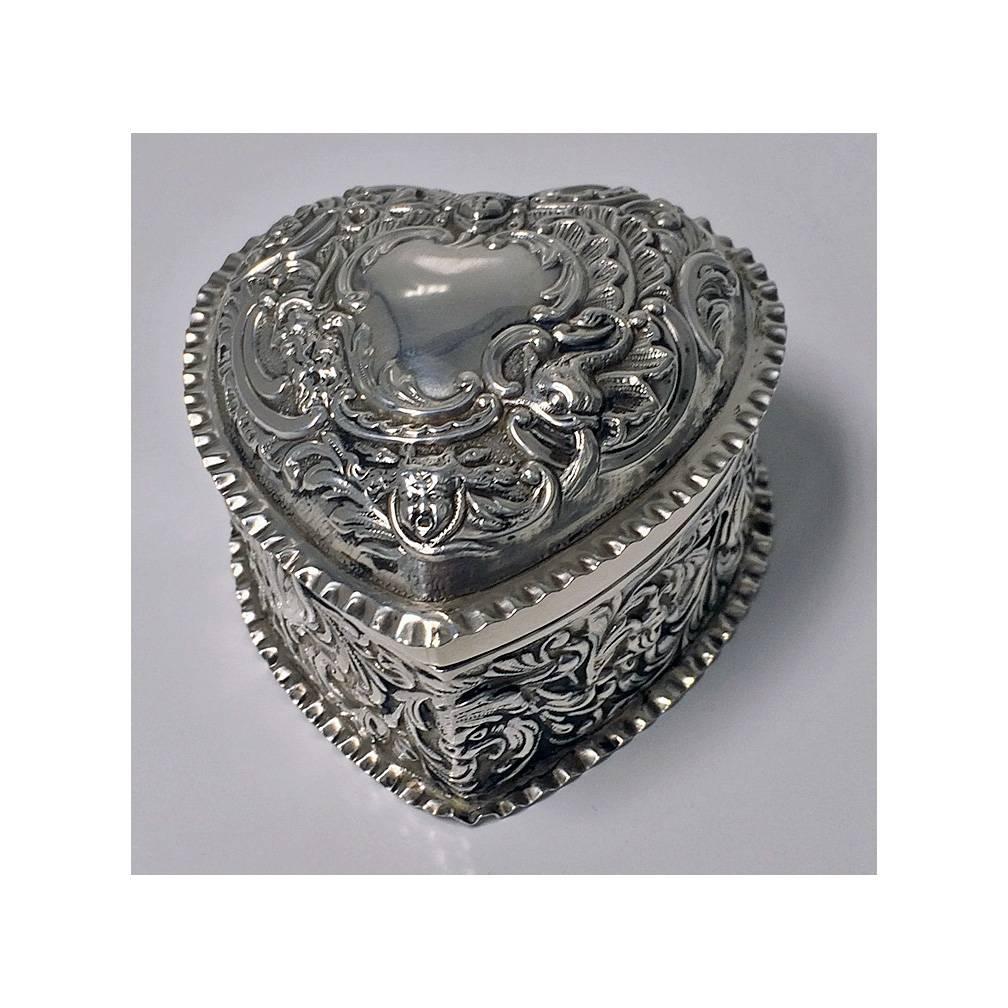 Antique Victorian silver heart box, London 1893, William Comyns. The box repoussé with birds, foliage and cherubs decoration. Fully hallmarked. Measures: Approximately 3 x 3 x 1.75 inches. Weight: 70.2 grams. Condition: Excellent. No erasures, no