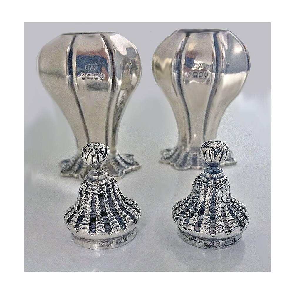 Fine pair of antique silver William 1V salt and pepper conch shell casters, bulbous bodies with conch design bases and similar design pierced detachable covers. London 1834 by William Hewitt. Measures: Height: 3 ½ inches. Weight: 139.3 gm.