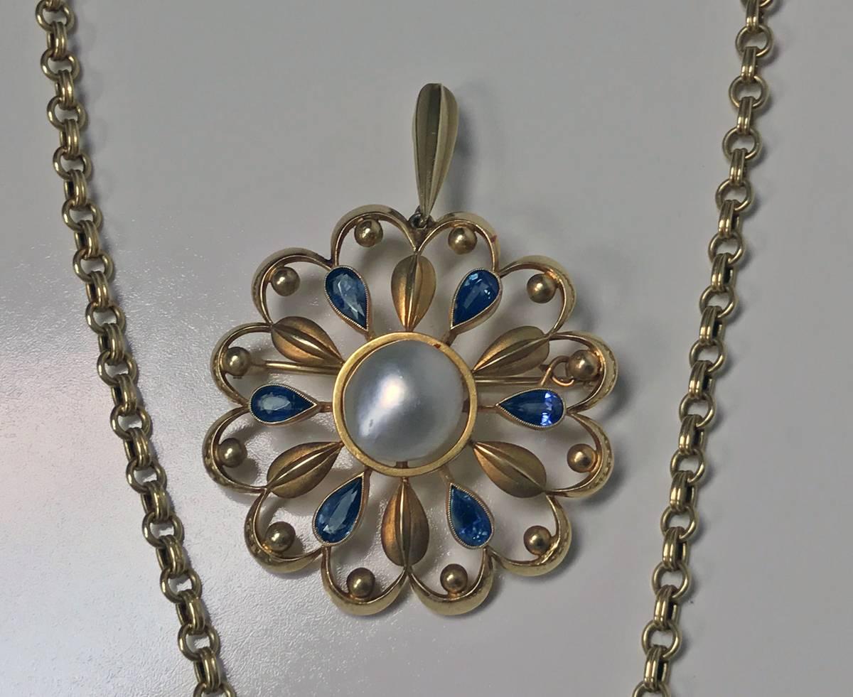 Very rare David Andersen gold pearl sapphire necklace, brooch and earrings, circa 1950. Custom-made open foliate design set with alternate blue sapphire, polished gold and matte petals with bead surround, earrings conforming in design, oval
