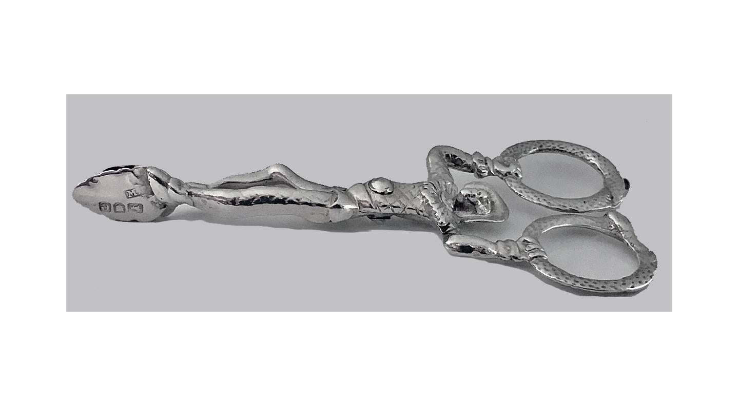 Pair of Victorian silver harlequin novelty sugar nips, London 1900, M. Freeman. The tongs formed as a monkey dressed as a Harlequin with acanthus leaf bowls and ouroboros snake handles. Length: 4.5 inches. Item weight: 44.67 grams.