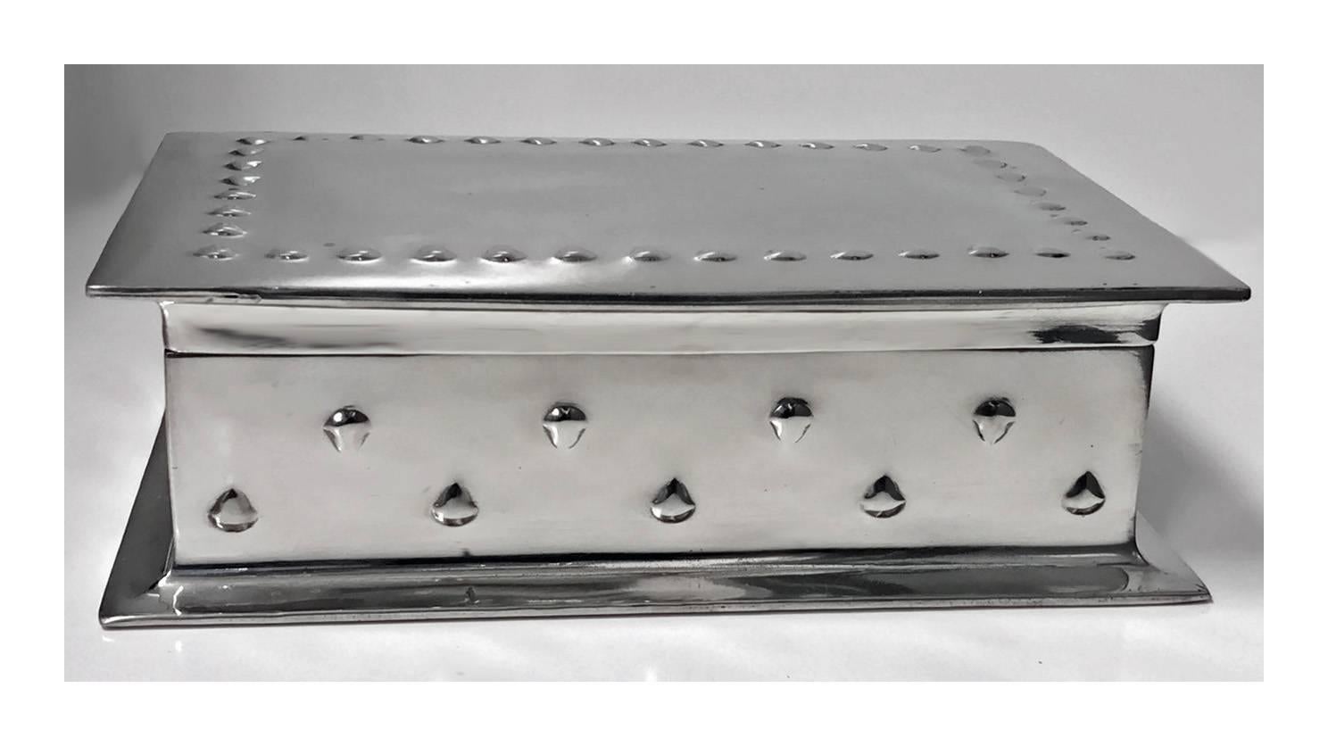 Large Liberty Arts and Crafts humidor box, designed by Archibald Knox, circa 1905. The box of rectangular polished hand planished pewter, with simple raised arrow motif decoration, original cedar lined interior. Marked to underside 078 and Tudric