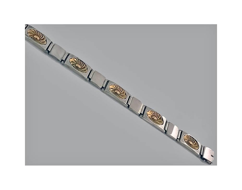 Georg Jensen Sterling bracelet, designed by Henry Pilstrup. The bracelet with alternate rectangular gold over sterling lotus links and square polished sterling links respectively. The 'lotus’ design was first created by Henry Pilstrup in 1937.