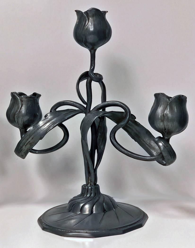 Art Nouveau candelabra candlesticks, Orivit, Germany, circa 1900. The polished pewter Jugendstil secessionist candelabra each on polygon base, supporting open stylised flowing organic foliate centres with three light conforming in design. Measures: