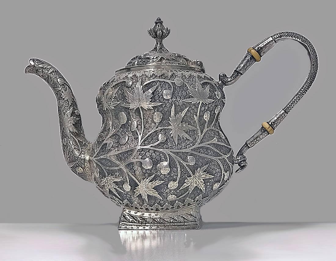 Silver tea set, probably Srinagar, Kashmir, India, for western market, circa 1910. Teapot, Cream and Sugar, rounded body, square bases, gilded interiors. Each with chasing and repousee work of chinar vegetal, floral seed pod and acanthus leaves
