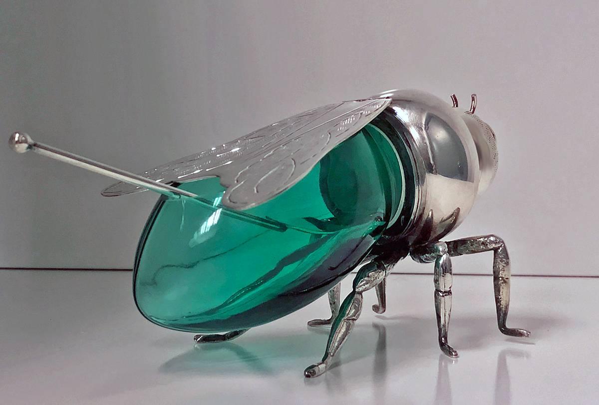 Silver plated and green glass figural bee honey pot, Teghini, Italy, circa 1930. The honey pot with hinged wings and detachable removable green glass body conforming in shape, protruding antennae on six realistically textured legs attached to the
