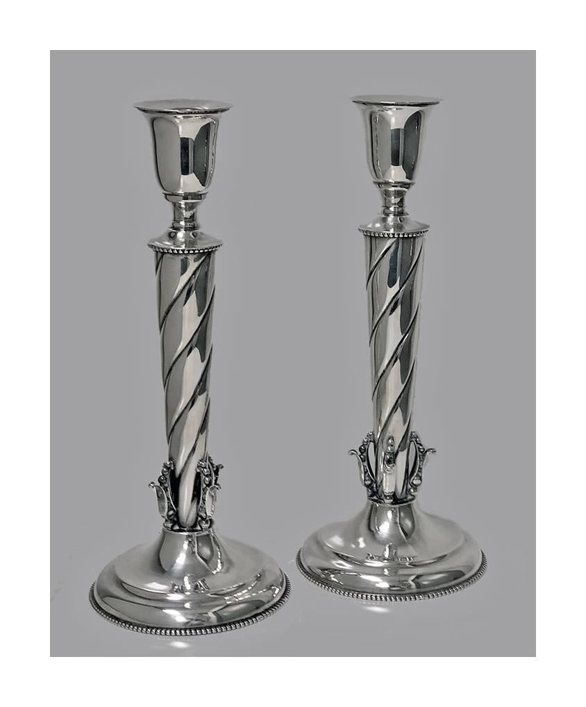 William De Matteo, silversmith for Georg Jensen, handmade sterling candlesticks, circa 1950. The candlesticks of bud leaf design, swirl tapered stems, accented with bead borders. Each marked Sterling de Matteo on underside. Measures: Height 11