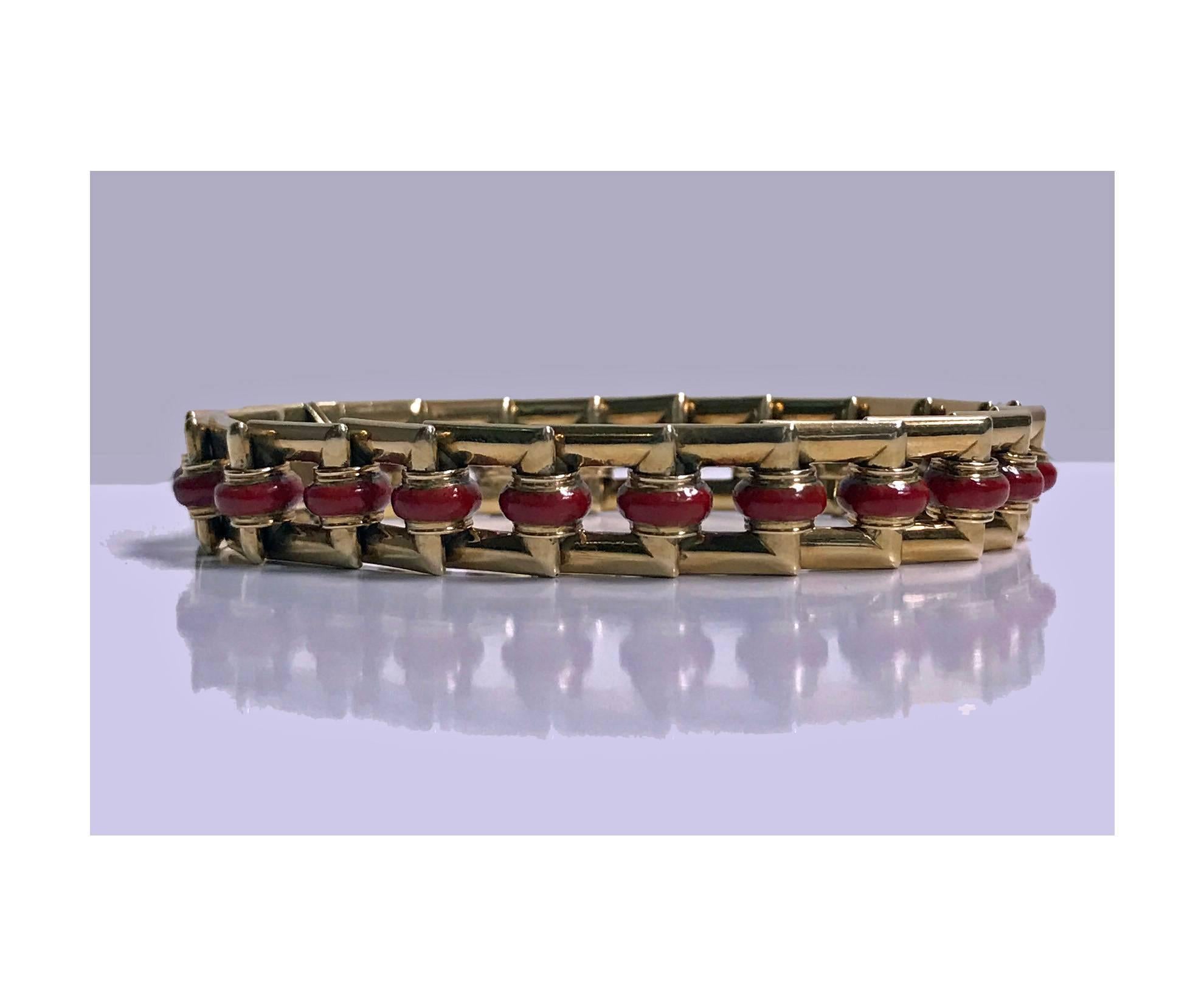 Art Deco 18-Karat carnelian bracelet, circa 1930. The bracelet with overlapping open rectangular links each with orange red carnelian rondelle, terminating with tongue and box clasp fastener. Measures: Length 7.25 inches. Item weight 40.32 grams.