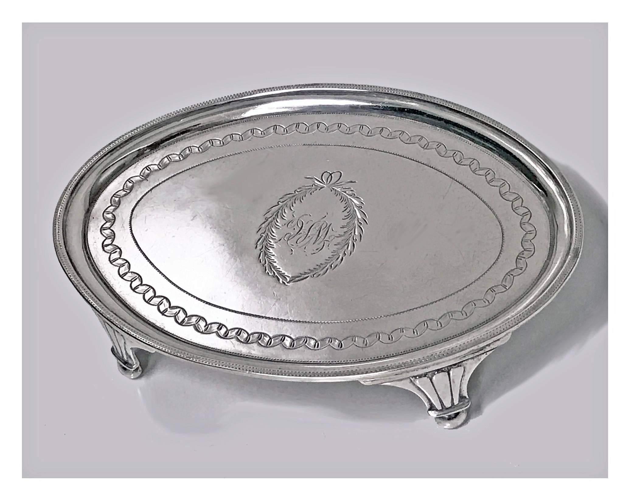 Georgian silver waiter salver or teapot stand, London, 1801, Urquhart and Hart. The oval small salver on four turned supports, the centre engraved with foliate cartouche and possibly WC, engraved pin prick design borders. Fully hall marked on