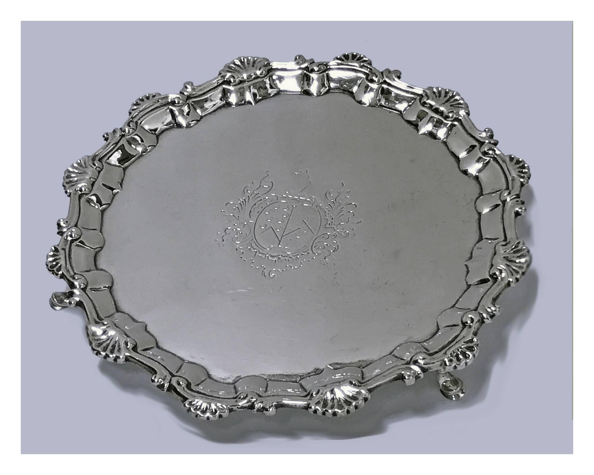 Georgian silver salver, London, 1757, William & Robert Peaston. The Salver with everted rim, Chippendale shaped border, engraved in the centre with marital coat of arms, border of applied scrolling decoration accented with alternating fluted shell