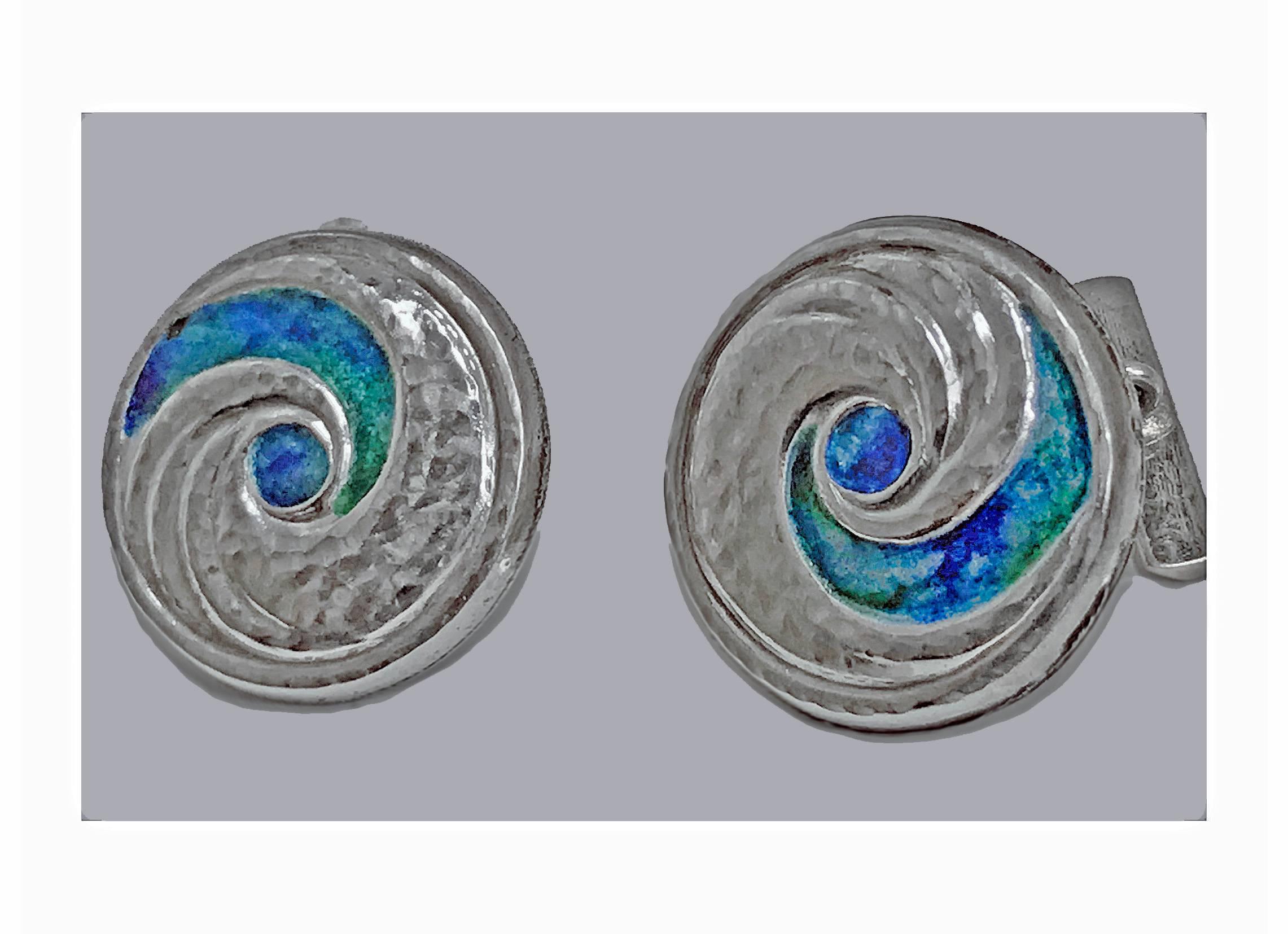 Pair of Liberty & Co Archibald Knox designed enamel cufflinks, Birmingham 1902-4. The circular slightly concave cufflinks with swirl hammered silver and green, blue, turquoise enamel. Chain and hemi rectangular bar fitments. Full Liberty marks to