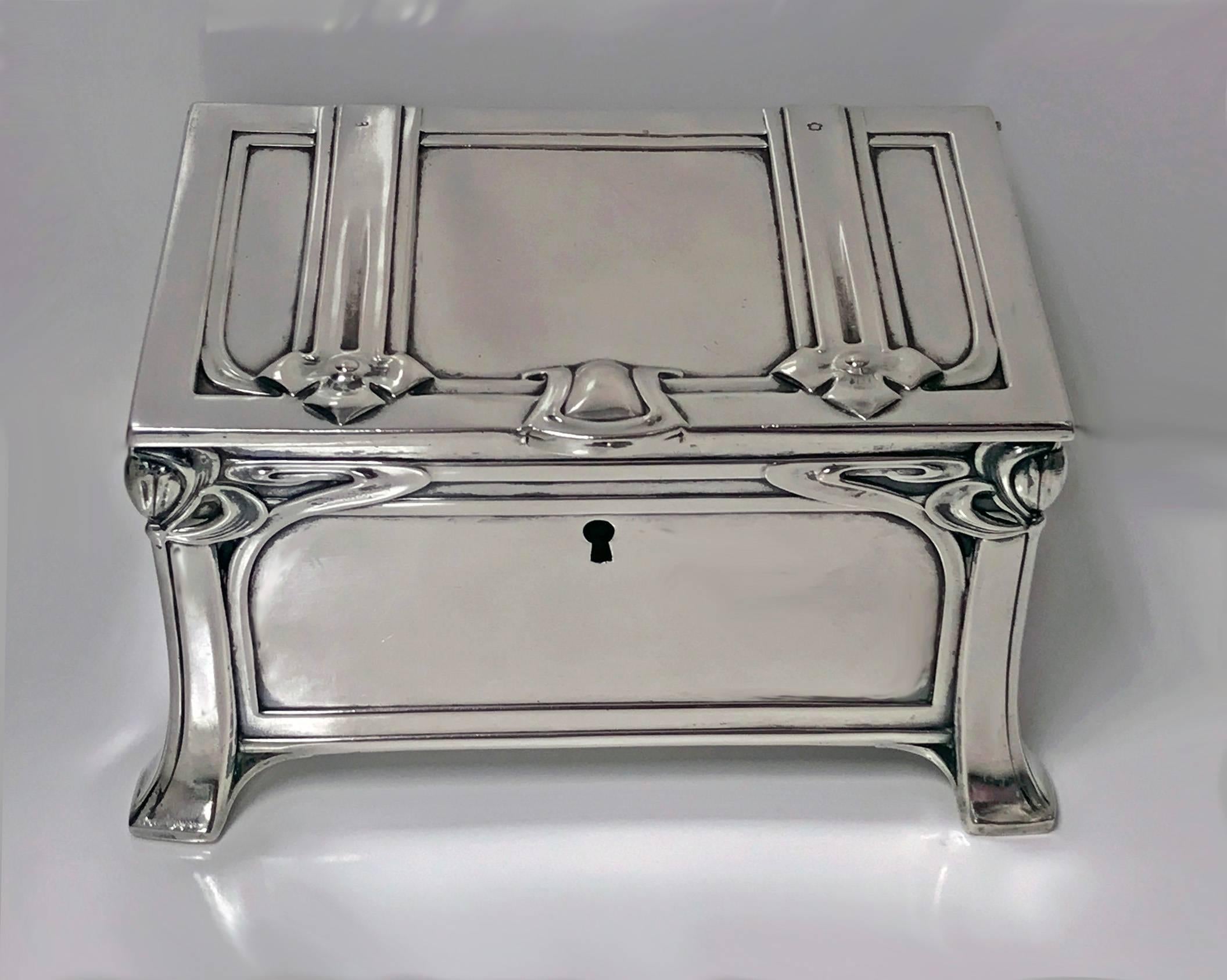 Austrian silver casket box, Vienna, circa 1900. The box of strong jugendstil nouveau secessionist design on four turned bracket stylized bracket supports, stylized upper border above plain panels, hinged cover. Interior gilt. Hallmarked. Good