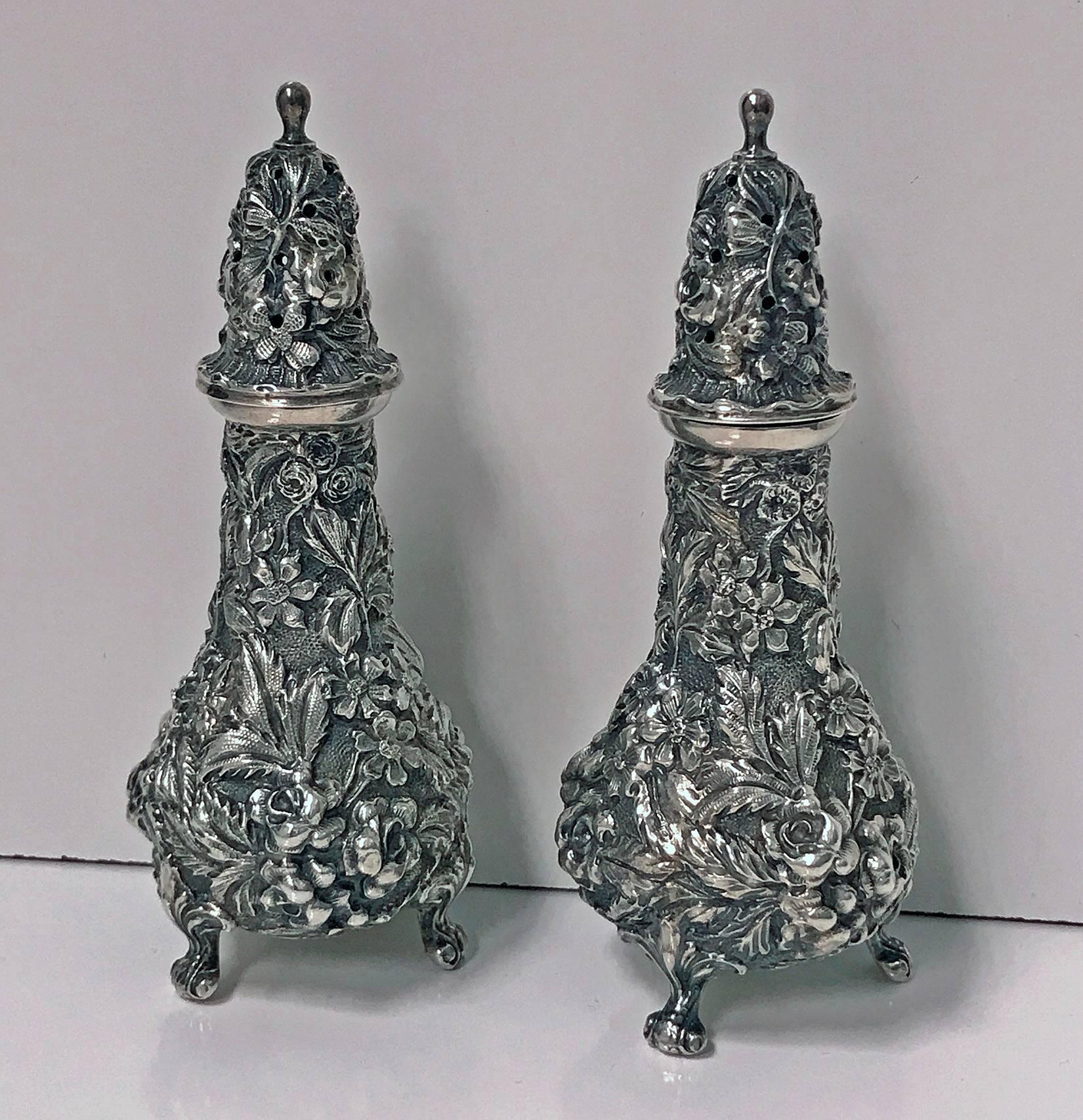 Pair of Stieff sterling silver rose repoussé casters, fully marked and date letter for 1915. Measure: height 4.5 inches. Weight 120.18 grams.