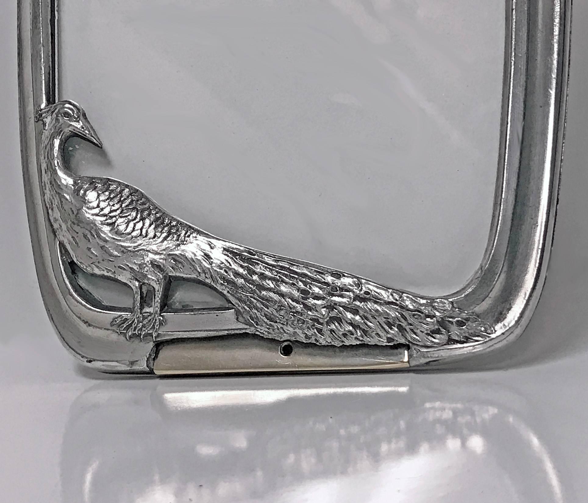 Art Nouveau Jugendstil peacock photograph frame, Argentor, Austria, circa 1900. The frame of a plain stylised Art Nouveau curvilinear border with a peacock realistically textured at lower left side. Original back and easel, stamped with marks for