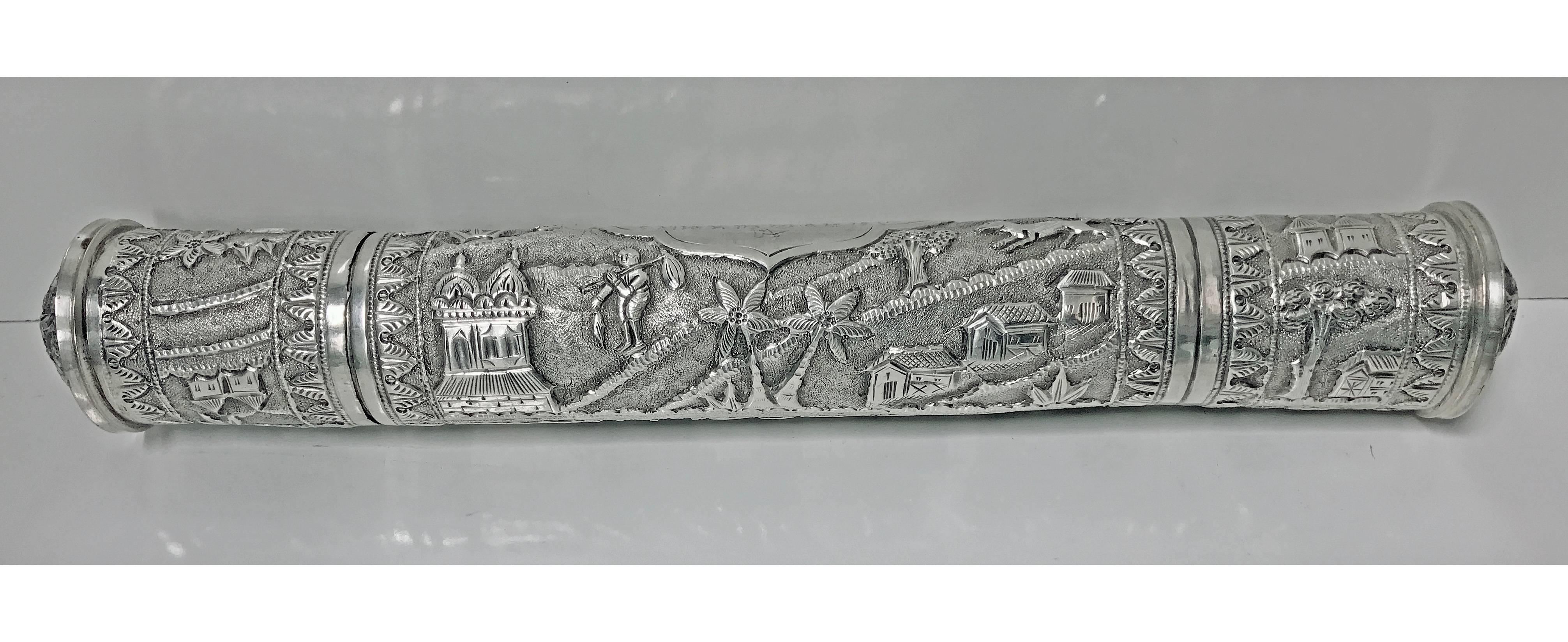 Antique silver scroll holder, circa 1900. The cylindrical container with relief scenic repoussé work decoration, slightly dome ends and pull off cover to one end, cartouche lightly pin prick engraving of possibly Arabic script verse. Length: 10.25