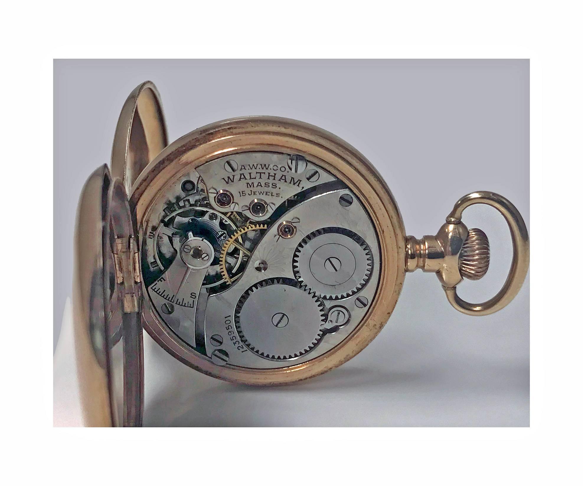 An American Waltham 14-karat stem wind Gold Hunter case pocket watch, circa 1900. Case width 33mm. White porcelain dial with black Roman numerals, and an outer five-minute increment scale in red enamel, subsidiary dial at 6; American Waltham