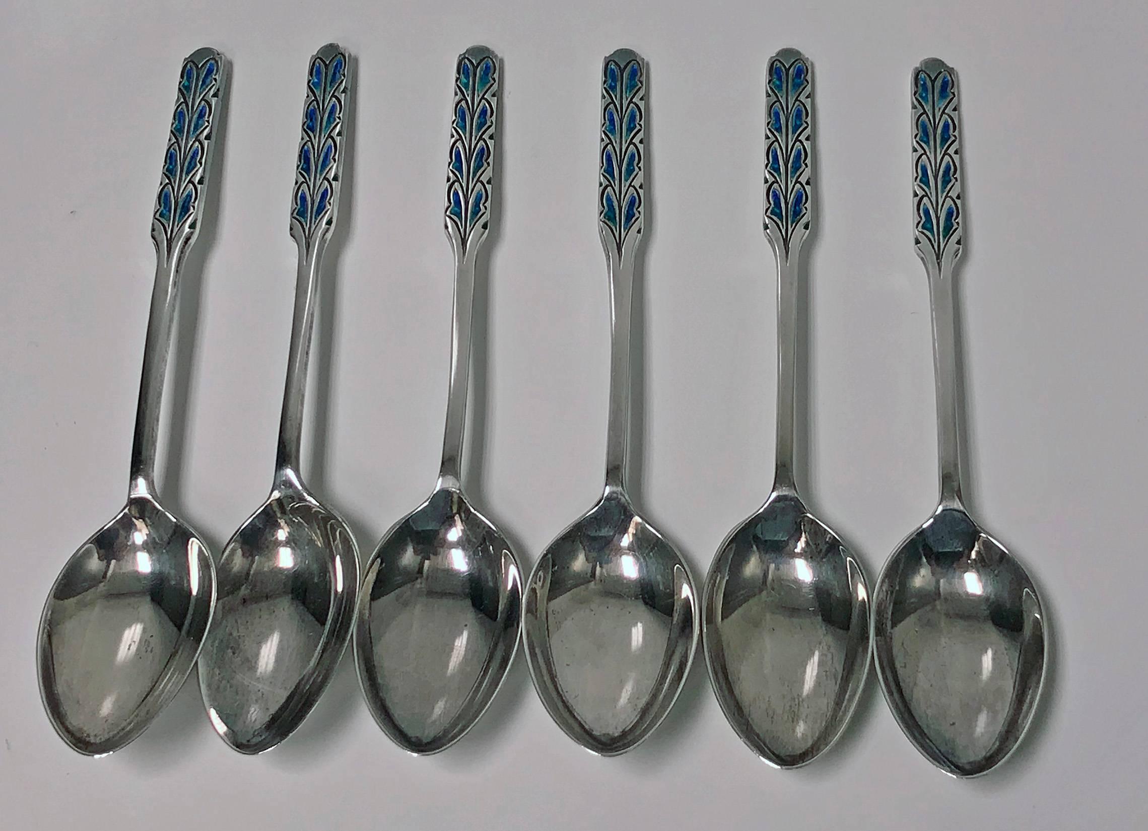 Set of Liberty and Co Enamel Sterling Silver Spoons, Birmingham 1925, fitted box. The six spoons all with enamel handles of varied turquoise color. Length: 4.5 inches. Total Item Weight: 70.82 grams. Original Box for G.L Connell Ltd Retailers for