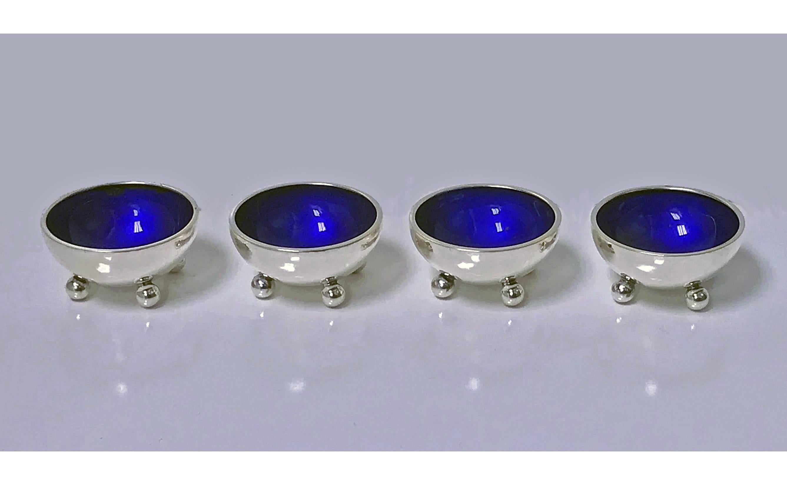 Four Georg Jensen sterling silver salts with cobalt enamel interiors, circa 1960, designed by Harald Neilsen, circa 1930. Design Number 433. Measures: diameter 1.50 inches, height 0.75 inches. Total item weight: 85.22 grams.