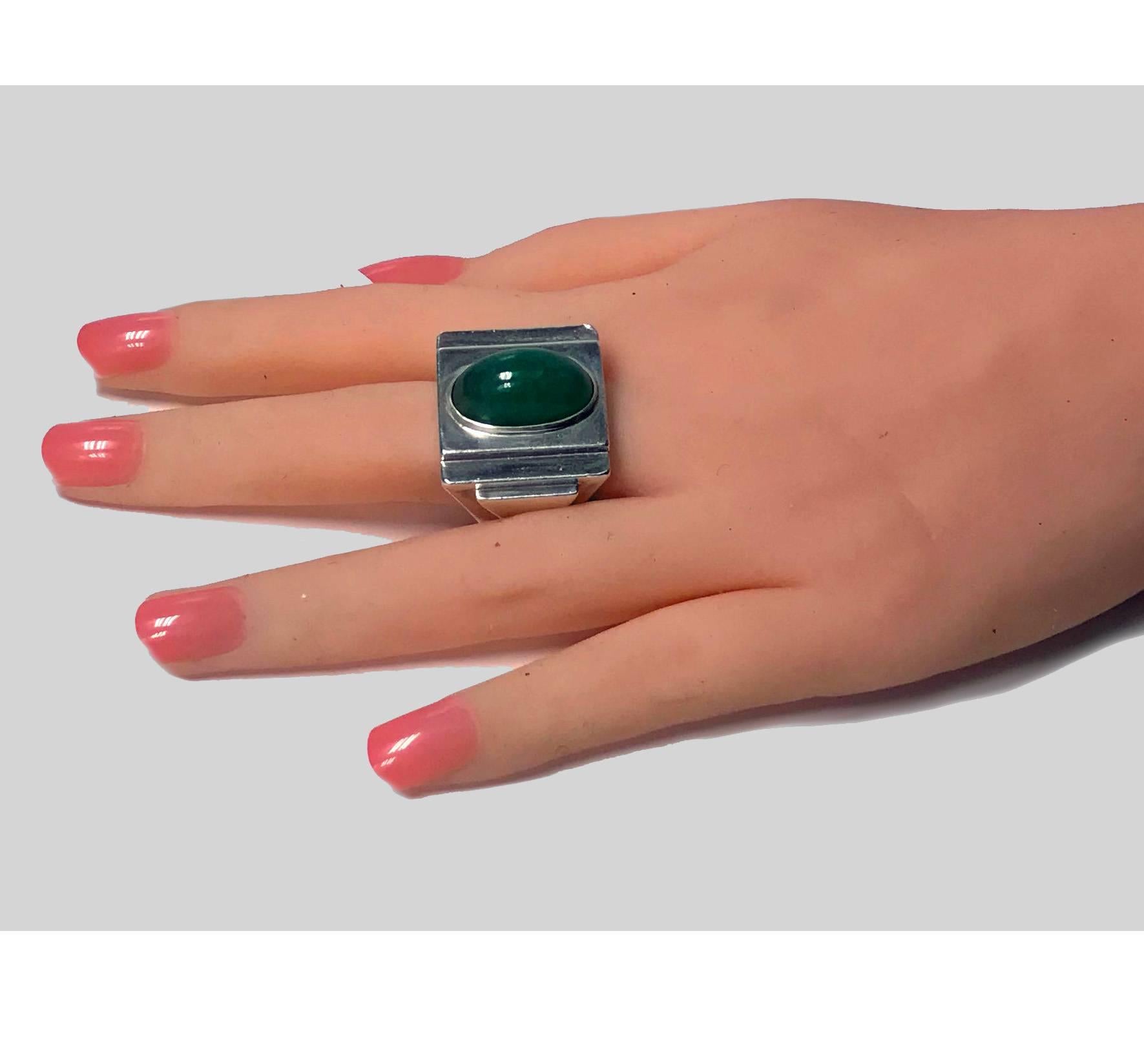 Bold striking Art Deco architectural design Ring, French import mark C.1920. The Silver Ring of large a geometric stepped quadrilateral form, bezel set in the centre with large oval cabochon green quartz. Marked with French swan import mark. Top of